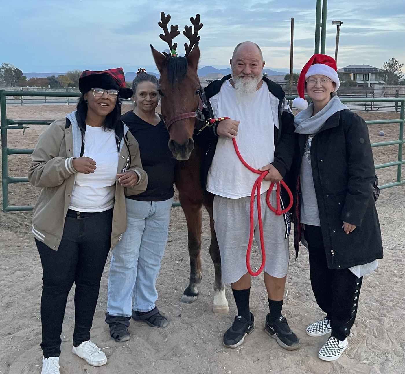 Residents and staff with a horse during a holiday community outing